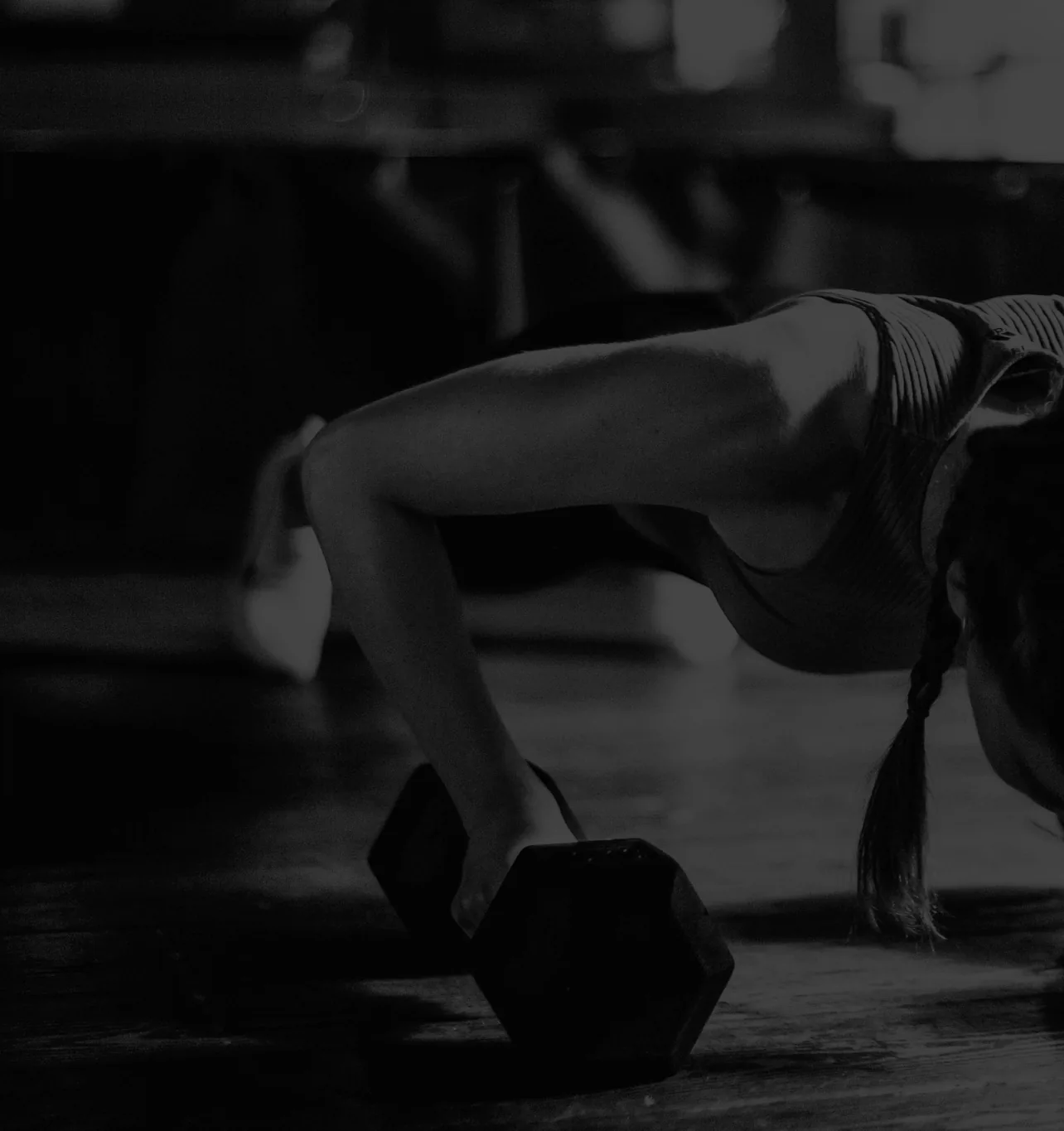 Coach guiding a member through a dumbbell strength session